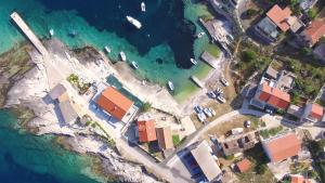 an aerial view of a group of houses and the ocean at Apartment Karuza Rukavac in Vis +8 photos