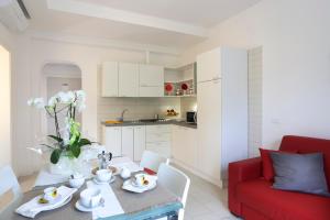 a living room with a table and a red couch at Residence Altea in Riccione