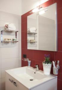 a bathroom with a sink and a mirror at Residence Altea in Riccione
