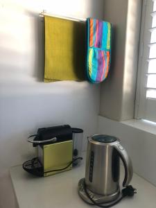 a kitchen counter with a tea kettle and a toaster at Allora Apartment Applecross in Perth