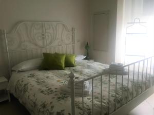 羅馬的住宿－Suite Manzoni，卧室配有带绿色枕头的白色床