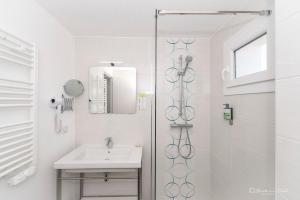 a bathroom with a shower and a sink at Hôtel George Sand in La Seyne-sur-Mer