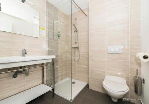 a bathroom with a shower and a toilet and a sink at Hôtel George Sand in La Seyne-sur-Mer