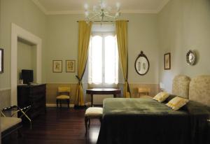 a bedroom with a bed and a window at Relais Teatro Argentina in Rome
