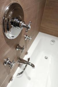 a bathroom with a sink and two faucets at Au Manoir Saint Germain in Paris +28 photos
