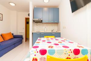 a kitchen and a table with a polka dot table cloth at • Lungomare Beach Apartment Pula • in Pula +18 photos