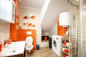 a bathroom with a toilet and a washing machine at Apartments MB in Kaštela +41 photos