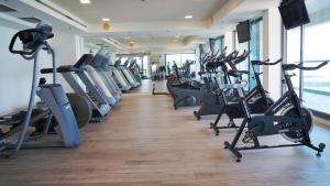 a gym with a row of treadmills and exercise bikes at Marina Towers - Herzeliya in Herzliya