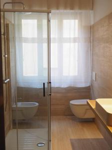 a bathroom with a shower and a toilet and a sink at Bel Fiore in San Benedetto del Tronto