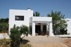 a white house with a courtyard in front of it at Casa las Marias in Hornachuelos