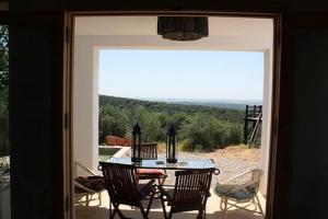 an open door to a patio with a table and chairs at Casa las Marias in Hornachuelos
