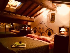 a bedroom with a bed with a iron head board at Molino dei Preti in Asciano