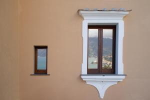 a window that is open with a vase on top of it at Villa Alba d'Oro - Historic Luxury Villa in Amalfi