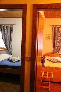 Postel nebo postele na pokoji v ubytování Garni Biancaneve Ruffrè-Mendola