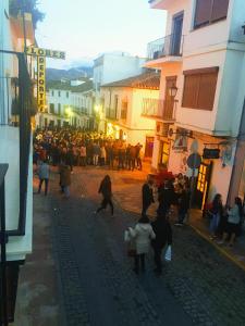 a crowd of people walking down a street at Casa Ronda 1808 in Ronda