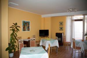 a living room with two tables and a tv at B&B Sole Luna in Perugia