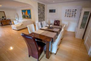 a dining room with a table and chairs at Villa Penkala Apartment in Opatija