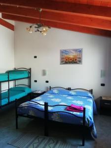 a bedroom with two bunk beds in a room at B&B S'Apposentu in Arbus