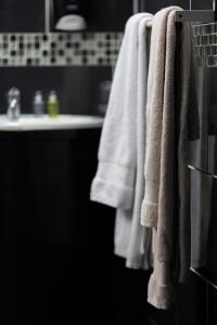 a bathroom with white towels hanging on a rack at Hôtel des Beaux Arts in Chambéry