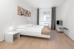 Postel nebo postele na pokoji v ubytování TGM Hotel Residence