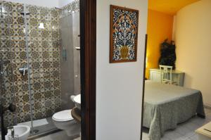 a bathroom with a toilet and a shower at Al-Tair in San Vito lo Capo +37 photos