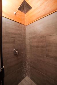 a bathroom with a shower with a shower head at Aqui hoy cabañas in Bocas del Toro
