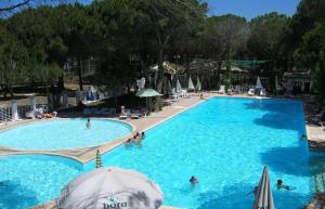 a large blue swimming pool with people in it at A beautiful Beach house Marea Resort in Golem