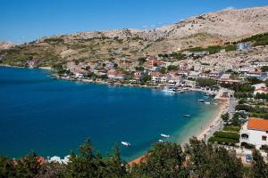 a view of a beach with boats in the water at Apartments Niko Metajna, island Pag in Metajna