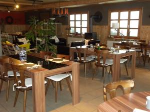 a dining room with wooden tables and chairs at Hotel Restaurant Walliser Sonne in Reckingen - Gluringen