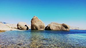 a group of large rocks in the water at Apartments Niko Metajna, island Pag in Metajna