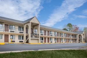 a large building with a parking lot in front of it at Super 8 by Wyndham Burlington NC in Burlington