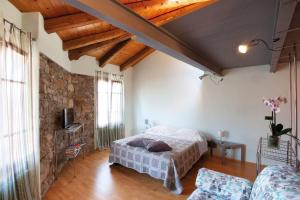 a bedroom with a bed and a brick wall at La Casetta in Piazzetta in Cormòns