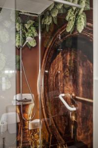 a bathroom with a shower with a large wooden barrel at Hotel Ertl in Kulmbach