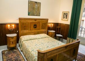 a bedroom with a large wooden bed and green curtains at B&B Santa Caterina in Palermo