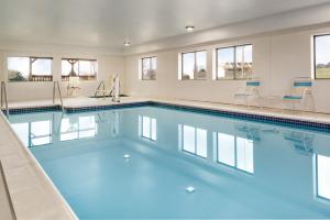 a swimming pool with blue water in a building at Super 8 by Wyndham Chambersburg I-81 in Chambersburg