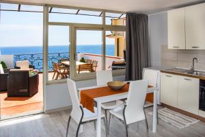 a kitchen and dining room with a view of the ocean at Loft Vista Sul Mare in Letojanni