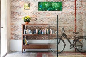 a bike parked next to a book shelf with books at Artrip Hotel in Madrid