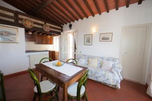 a living room with a table and a couch at L'Oleandro Colle D'Orano in La Guardia