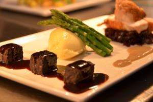 a plate of food with chocolate covered food and asparagus at The Riviera Hotel & Apartments - Alum Chine in Bournemouth