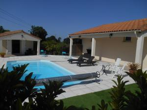 a swimming pool in the backyard of a house at Chambres d'hôtes LA COZY in Cozes
