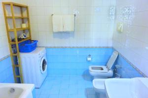 bagno blu con servizi igienici e lavandino di Ca' Nova Apartments a Bassano del Grappa