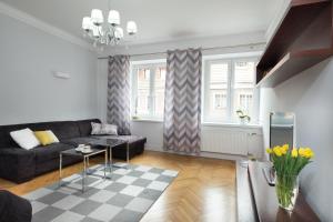 a living room with a couch and a table at Prosta Apartment Old Town in Olsztyn