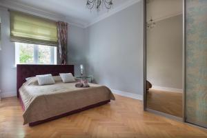 a bedroom with a bed and a sliding glass door at Prosta Apartment Old Town in Olsztyn