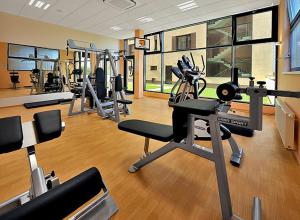 a gym with treadmills and elliptical machines at Melrose Apartments in Bratislava