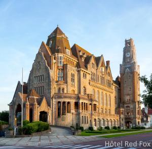 a large building with a clock tower on top at Red Fox in Le Touquet-Paris-Plage