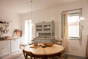 a kitchen with a wooden table with a bowl on it at Locanda Li Manni in Aggius
