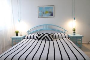 Łóżko lub łóżka w pokoju w obiekcie Eleatica Holiday Apartment