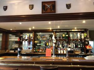 a bar with a lot of bottles of alcohol at The Woolaston Inn in Lydney