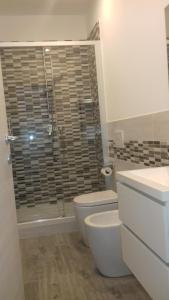a bathroom with a toilet and a glass shower at Ca di Ale in Lerici +28 photos