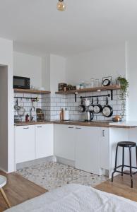 a kitchen with white cabinets and a counter top at Studio apartman Knežija in Zagreb